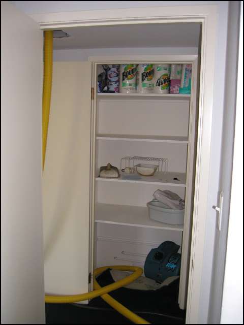 Dryer blowing air under the rug in the linen closet