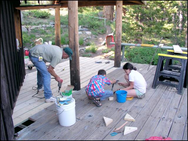 Randy then cuts the new boards to fit and Jay stains the bottoms and sides
