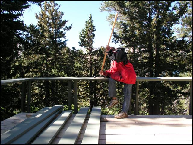 Laura is sanding the railing for another coat of stain.