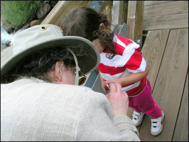 Mommy is taking out a splinter from the bridge