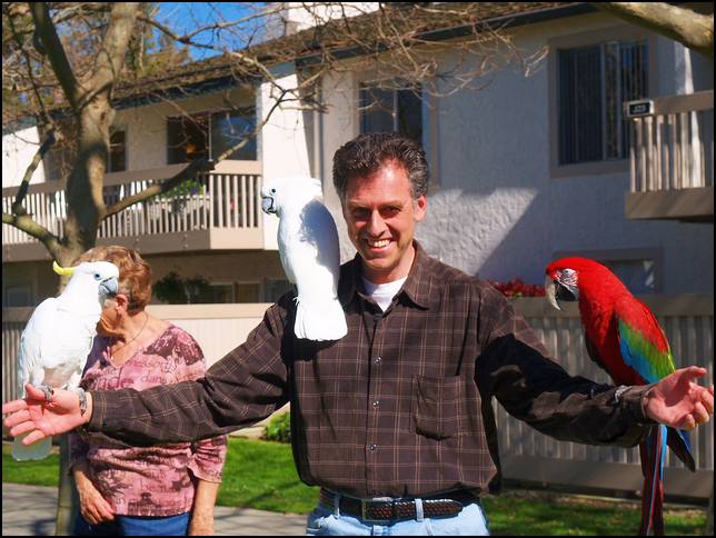 A big guy gets to hold three birds!