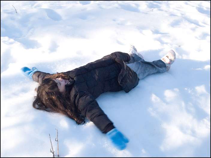 Sydney making a snow angel