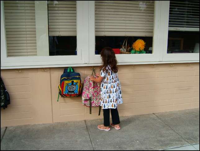 Sydney is hanging up backpack outside of the classroom (did I mention this is California where almost everything is outside!)