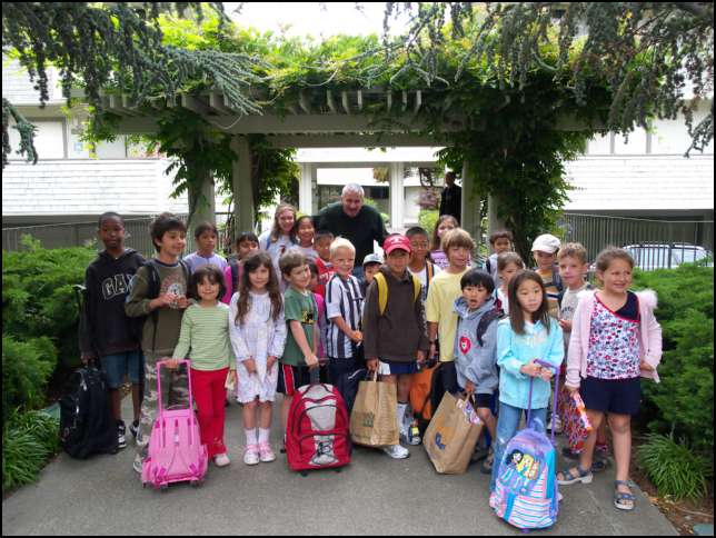 Group portriat of Stop number 5 kids with Ron their morning bus driver on his last day