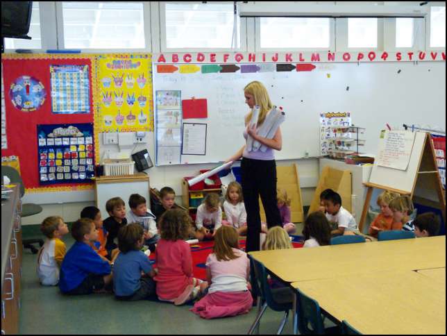 Miss Tyler is handing out special pictures and a gift